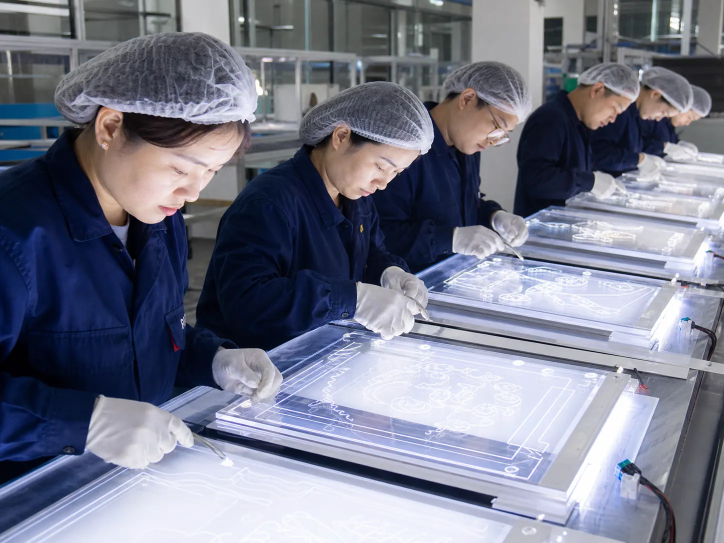 Chinese quality inspectors checking LED fluorescent boards